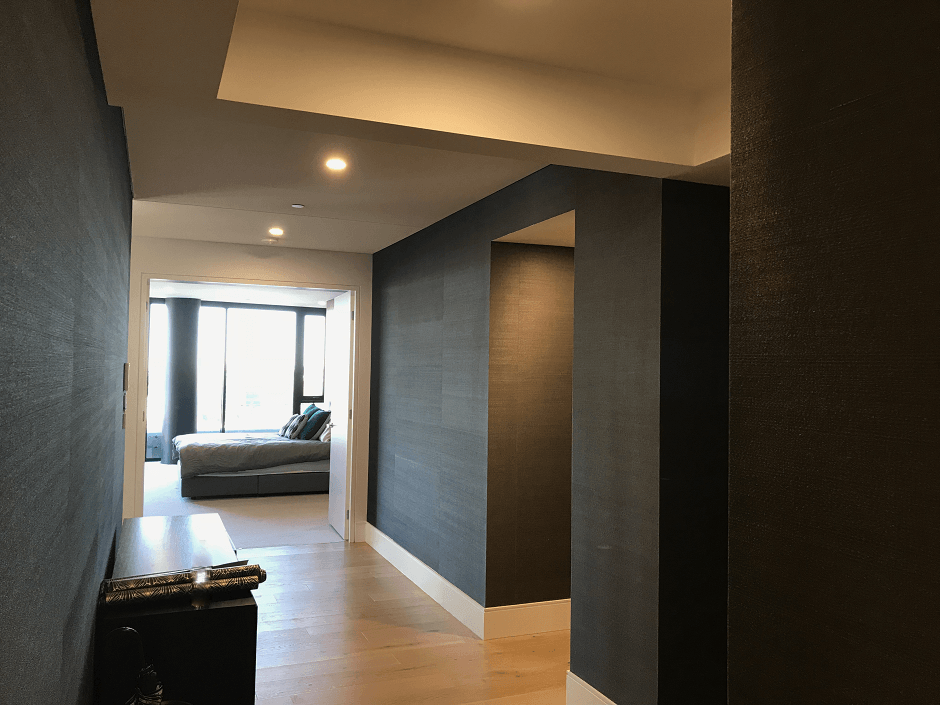 Boyd Blue black grasscloth wallpaper in entry foyer of an apartment in Brisbane