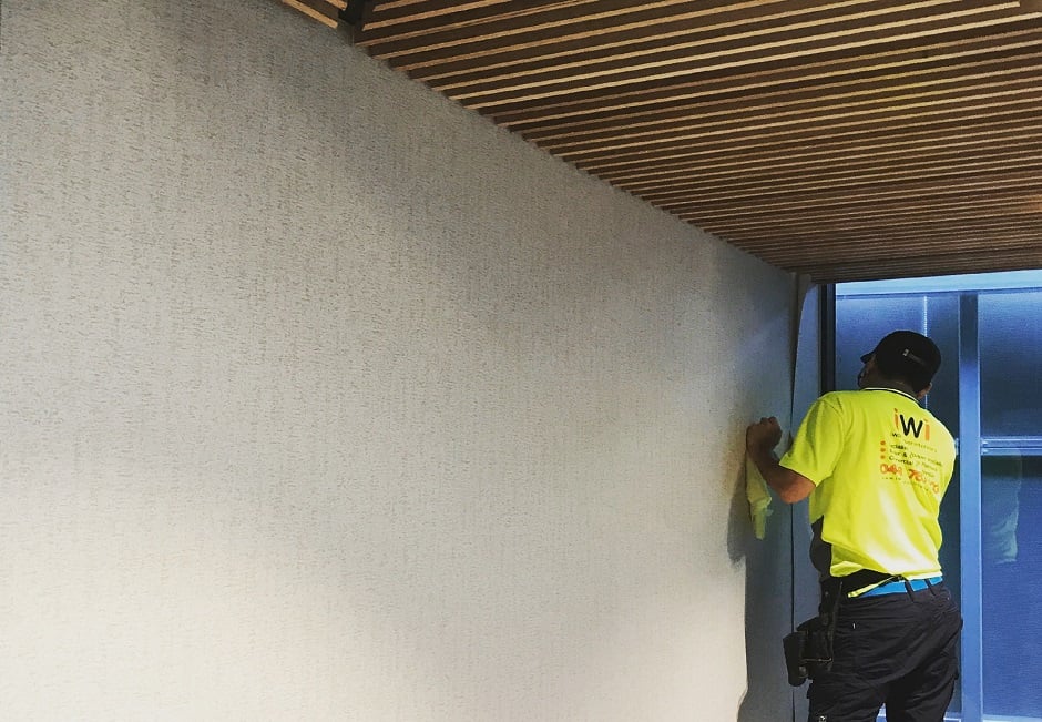I Wallpaper Interiors installer hanging wallpaper on commercial job