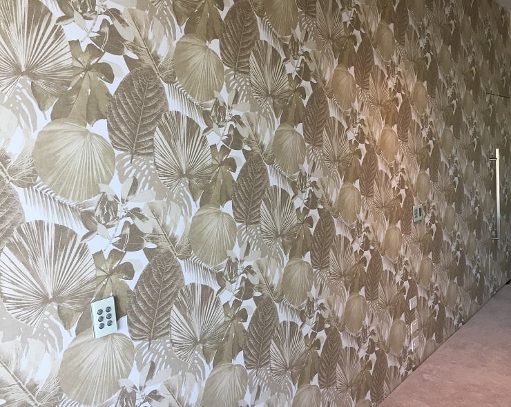 Gold leaf patterned wallpaper with hidden door