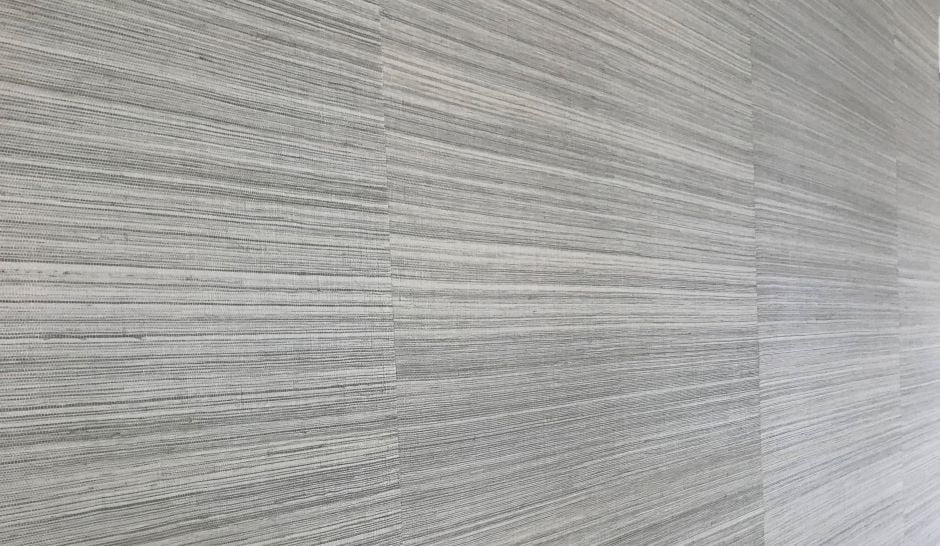 close up photo of a grey grasscloth wallpaper