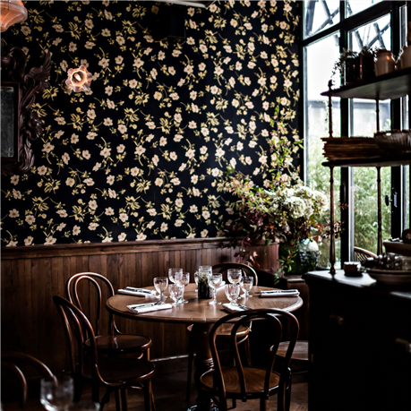 Poppys on black wallpaper in a cafe