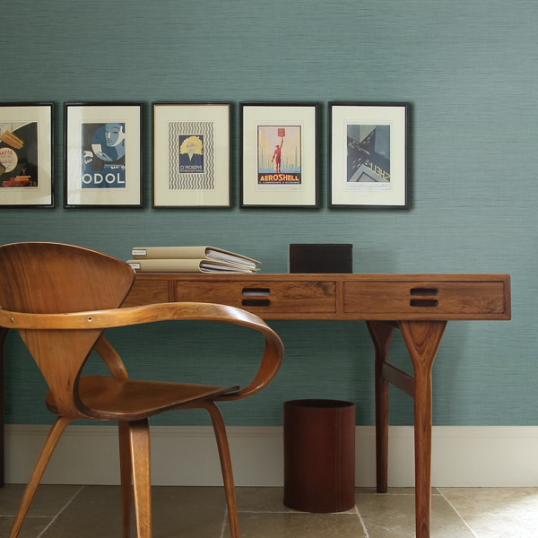 Deep mint green wallpaper against timber furniture