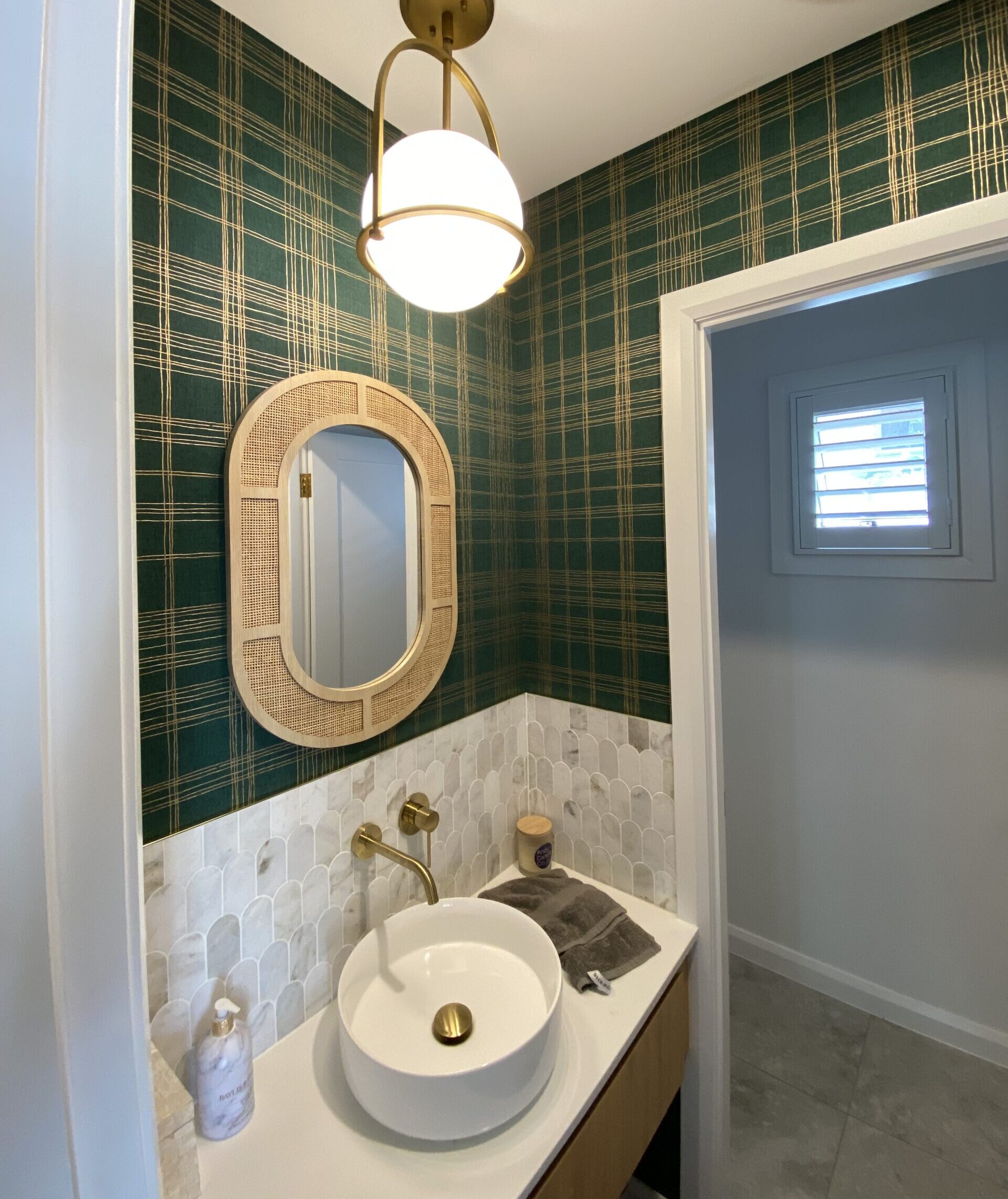 Green check wallpaper in powder room