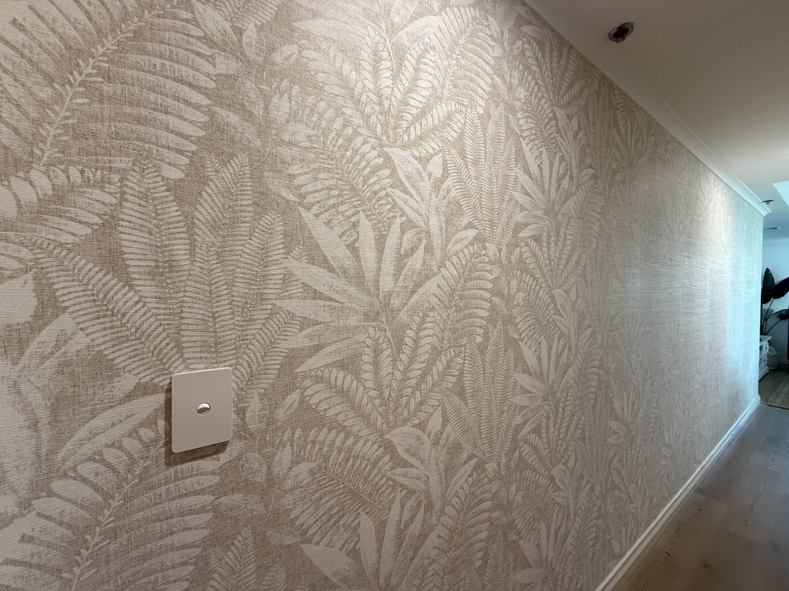 Aloes wallpaper in beige on an entry wall