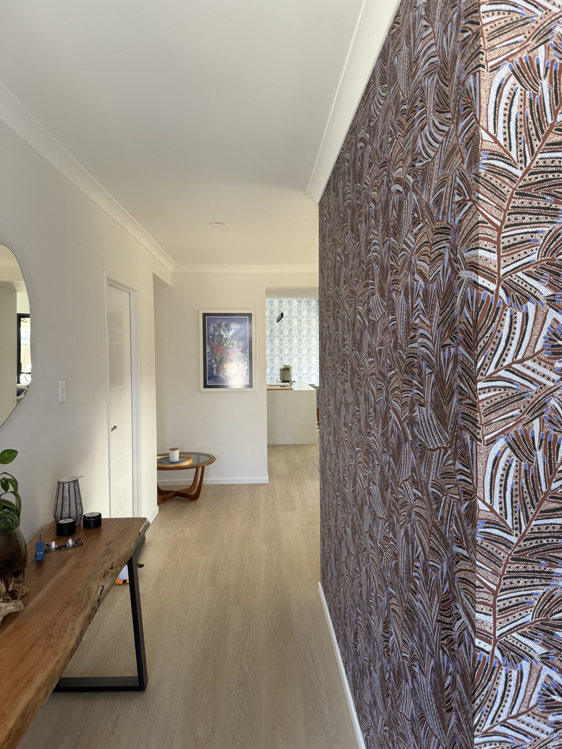 Papunya Australiana wallpaper in blues and maroon seen in the home entry with a 2nd wallpaper in the background