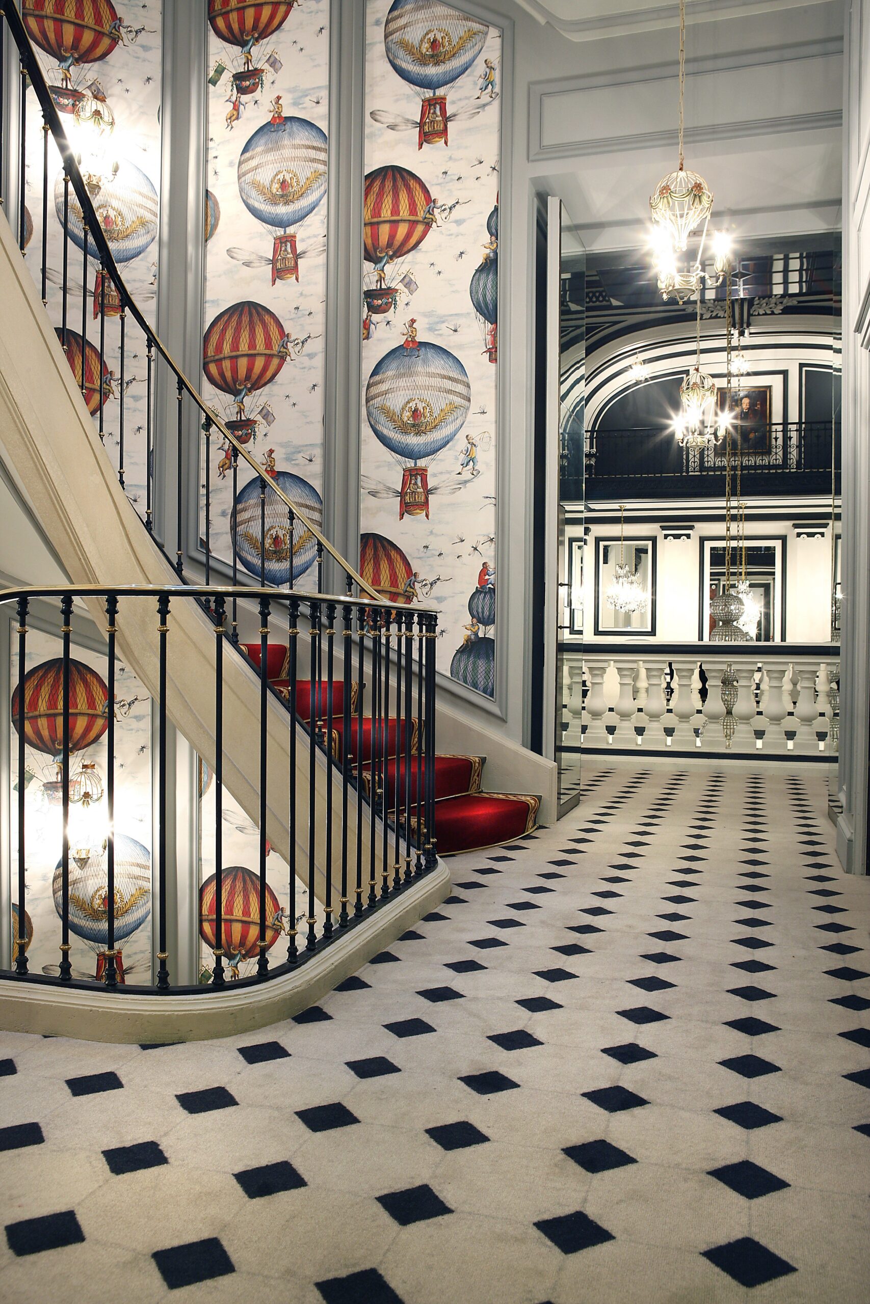 Staircase of St. James Hotel Paris with hot air balloon wallpaper on staircase