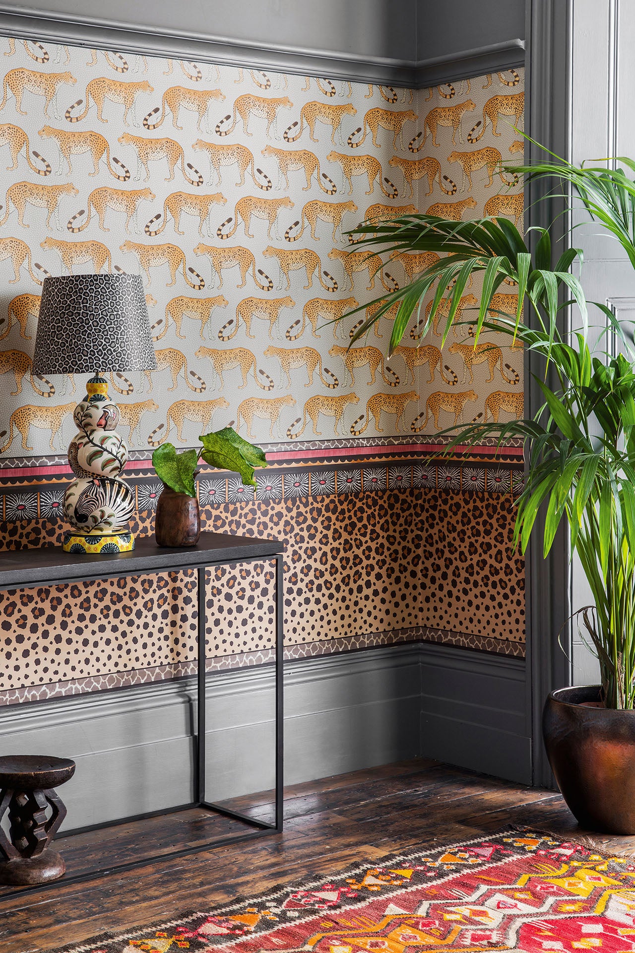 Cole and Sons Zulu border using two wallpapers on one wall for maximalist interior design