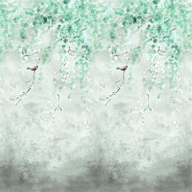A scene of cherry blossoms trailing down the wall in a striking green wallpaper mural