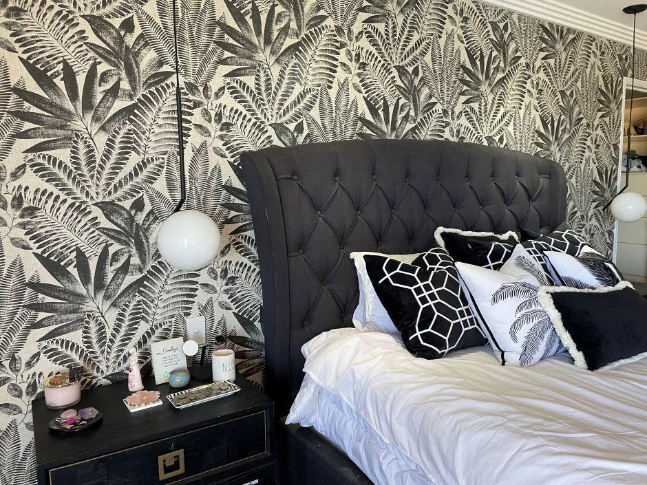 Aloes wallpaper in black on a bedroom wall